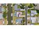 Aerial view of the home with a private pool, boat dock, and waterfront access with city skyline views at 136 Reef Rd, South Daytona, FL 32119