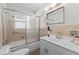 Bathroom with bathtub, frosted glass doors, decorative tile, stylish vanity, and floral accent at 136 Reef Rd, South Daytona, FL 32119