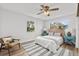 Bedroom with accent chair, ceiling fan, wood-look floors, two windows offering outdoor views at 136 Reef Rd, South Daytona, FL 32119