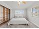 Bedroom with built in closet, plush carpet, ceiling fan, and sunny window with blinds at 136 Reef Rd, South Daytona, FL 32119
