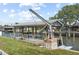 Waterfront property featuring a private boat dock with boat lift and covered area for convenient water access at 136 Reef Rd, South Daytona, FL 32119