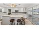 Kitchen with stainless appliances, granite countertops, a breakfast bar, and seamless indoor/outdoor flow to the patio at 136 Reef Rd, South Daytona, FL 32119