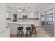 Kitchen featuring granite countertops, white cabinetry, breakfast bar and easy access to patio and outdoor spaces at 136 Reef Rd, South Daytona, FL 32119