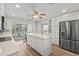 Bright, modern kitchen featuring stainless steel appliances, a center island, and lots of storage space at 136 Reef Rd, South Daytona, FL 32119