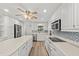 Modern kitchen featuring stainless steel appliances, granite countertops, a center island, and ample cabinet space at 136 Reef Rd, South Daytona, FL 32119