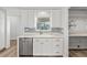 Kitchen featuring stainless appliances, light cabinetry and granite countertops, plus a connected pantry and backyard views at 136 Reef Rd, South Daytona, FL 32119