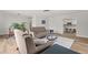 Inviting living space featuring modern decor, hardwood floors, and a view of the adjacent kitchen at 136 Reef Rd, South Daytona, FL 32119