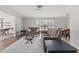 Open-concept living space features modern decor, hardwood floors, and a view of the adjacent dining room at 136 Reef Rd, South Daytona, FL 32119