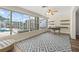 Sun-drenched office with large windows, custom shelving, and a contemporary desk and chair at 136 Reef Rd, South Daytona, FL 32119