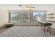 Light-filled home office with large windows overlooking the pool, custom shelving, and contemporary decor at 136 Reef Rd, South Daytona, FL 32119
