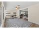 Bright and airy home office featuring modern shelving, comfortable seating, and seamless access to living spaces at 136 Reef Rd, South Daytona, FL 32119