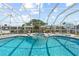 Sparkling backyard pool and spa combo framed by a screened enclosure and lush landscaping at 136 Reef Rd, South Daytona, FL 32119