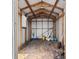 View of the storage shed interior, showing exposed wooden beams, a concrete foundation, and storage opportunities at 136 Reef Rd, South Daytona, FL 32119