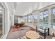 Bright sunroom featuring large windows, tile flooring, comfortable seating, and access to the pool area at 136 Reef Rd, South Daytona, FL 32119