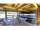 Covered boat dock with boat lift, ceiling fan, furniture, and electrical connections at 1640 Juno Trl # 202E, Astor, FL 32102