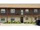 Close up exterior of unit featuring a private balcony, well kept landscaping, and covered walkway at 1640 Juno Trl # 202E, Astor, FL 32102