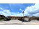 Exterior shot of building with covered parking featuring well-maintained grounds and blue sky at 1640 Juno Trl # 202E, Astor, FL 32102