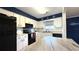 Cozy kitchen with modern appliances, granite counters and backsplash, and custom cabinetry at 1640 Juno Trl # 202E, Astor, FL 32102