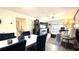 Inviting living area with modern décor, stylish dining set, and sliding glass doors to the balcony at 1640 Juno Trl # 202E, Astor, FL 32102