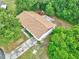 Aerial view of this home with a new roof surrounded by lush greenery and a long driveway at 2101 Almond St, Orange City, FL 32763