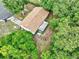 Aerial view of home and wooded lot with back porch and landscaping at 2101 Almond St, Orange City, FL 32763