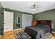 The bedroom is painted green with hardwood floors, and has a mirror and double door closet at 2101 Almond St, Orange City, FL 32763