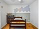 Cozy bedroom has light hardwood floors and calming wall decor at 2101 Almond St, Orange City, FL 32763