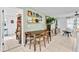 A dining room featuring a table, chairs, tile flooring, and shelves with records on a light green wall at 2101 Almond St, Orange City, FL 32763