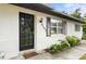 The front door of the home, flanked by plants and a colorful doormat, is inviting at 2101 Almond St, Orange City, FL 32763