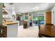 Kitchen area featuring stainless steel appliances, white cabinetry, and a light-filled dining space at 2101 Almond St, Orange City, FL 32763