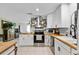 A renovated kitchen with stainless steel appliances, white cabinets, and butcher block countertops at 2101 Almond St, Orange City, FL 32763