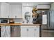 A kitchen sink with white cabinetry, butcher block countertops, stainless steel appliances, and black hardware at 2101 Almond St, Orange City, FL 32763