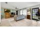 Cozy living room featuring tile floors, a neutral sofa, and a view of the front door at 2101 Almond St, Orange City, FL 32763