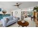 A cozy living room with tile flooring, ceiling fan, and an open layout, seamlessly blending comfort with functionality at 2101 Almond St, Orange City, FL 32763