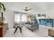 Inviting living room featuring a stylish sofa, tile flooring, and natural light through sheer curtains at 2101 Almond St, Orange City, FL 32763