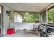 Enjoy relaxing on this screened porch featuring a grill and relaxing rocking chair at 2101 Almond St, Orange City, FL 32763