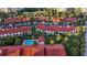 Aerial view of townhomes with a community pool surrounded by palm trees and green space at 2934 Oceans Trce, Daytona Beach Shores, FL 32118