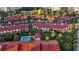 Aerial view of townhomes with a community pool surrounded by palm trees and green space at 2934 Oceans Trce, Daytona Beach Shores, FL 32118