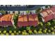 Aerial view of a townhome with a red roof in a tropical community, showing the parking and backyard at 2934 Oceans Trce, Daytona Beach Shores, FL 32118
