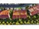 Aerial view of a townhome with a red roof in a tropical community, showing the parking and backyard at 2934 Oceans Trce, Daytona Beach Shores, FL 32118