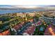 Charming aerial view of townhomes with red tile roofs, a pool, and ocean views beyond at 2934 Oceans Trce, Daytona Beach Shores, FL 32118