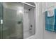 Updated bathroom features a glass-enclosed shower, white cabinets, and toilet at 2934 Oceans Trce, Daytona Beach Shores, FL 32118