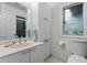 Bathroom features a single vanity, white cabinets, and toilet at 2934 Oceans Trce, Daytona Beach Shores, FL 32118