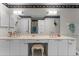 Large bathroom featuring dual sinks, large mirrors, and white cabinetry at 2934 Oceans Trce, Daytona Beach Shores, FL 32118