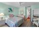 Well-lit bedroom with ceiling fan, hardwood floors, and view to backyard at 2934 Oceans Trce, Daytona Beach Shores, FL 32118