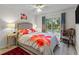 Bright bedroom with ceiling fan, large window, hardwood floors, and neutral walls at 2934 Oceans Trce, Daytona Beach Shores, FL 32118