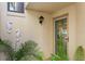 Charming townhome entrance featuring a blue door, seahorse decor, and lush green plants at 2934 Oceans Trce, Daytona Beach Shores, FL 32118