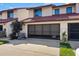 Townhome exterior with a two-car garage and a neatly kept lawn at 2934 Oceans Trce, Daytona Beach Shores, FL 32118