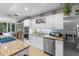 Bright kitchen featuring granite counters, stainless steel appliances, and white cabinetry at 2934 Oceans Trce, Daytona Beach Shores, FL 32118