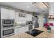 Gourmet kitchen featuring granite countertops, stainless steel appliances, and stylish lighting fixtures at 2934 Oceans Trce, Daytona Beach Shores, FL 32118
